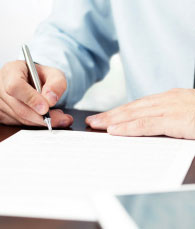 Man signing professional license